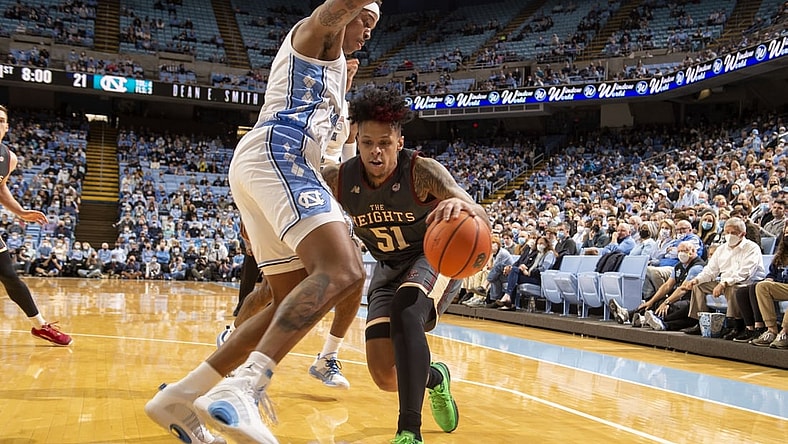 Jan 26, 2022; Chapel Hill, North Carolina, USA;  Boston College Eagles guard Brevin Galloway (51) with the ball as North Carolina Tar Heels forward Armando Bacot (5) and guard Leaky Black (1) defend in the first half at Dean E. Smith Center. Mandatory Credit: Bob Donnan-USA TODAY Sports