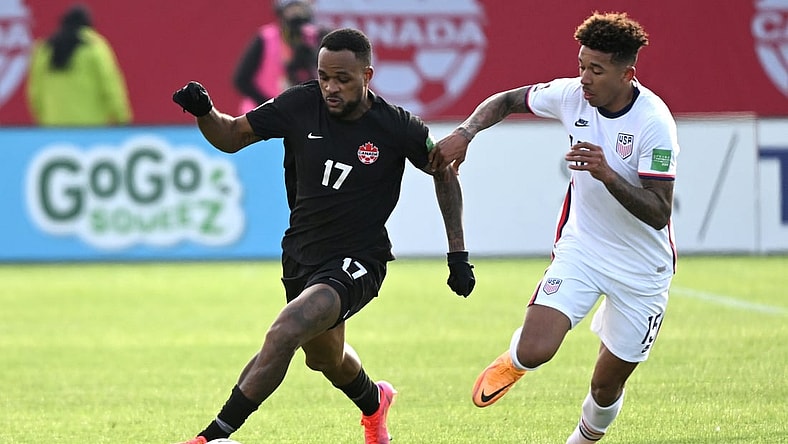 Jan 30, 2022; Hamilton, Ontario, CAN; Canada forward Cyle Larin (17) dribbles the ball away from United States defender Chris Richards (15) during a CONCACAF FIFA World Cup Qualifier soccer match at Tim Hortons Field. Mandatory Credit: Dan Hamilton-USA TODAY Sports