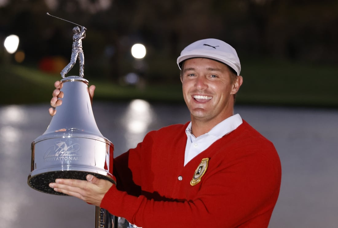 Mar 7, 2021; Orlando, Florida, USA; Bryson DeChambeau holds the champions trophy after winning the Arnold Palmer Invitational golf tournament at Bay Hill Club & Lodge. Mandatory Credit: Reinhold Matay-USA TODAY Sports