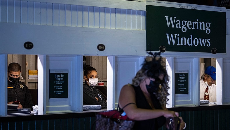 Attendants place bets at the wagering windows on the day of the 147th Kentucky Derby at Churchill Downs. May 1, 2021

As 8368derby Drop3