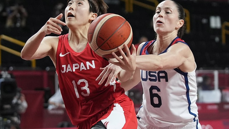 Aug 8, 2021; Saitama, Japan; United States guard Sue Bird (6) knocks the ball away from Japan point guard Rui Machida (13) in the women's basketball gold medal match during the Tokyo 2020 Olympic Summer Games at Saitama Super Arena. Mandatory Credit: James Lang-USA TODAY Sports