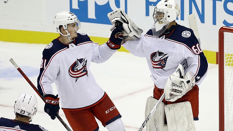 Sep 27, 2021; Pittsburgh, Pennsylvania, USA; Columbus Blue Jackets defenseman Stanislav Svozil (81) congratulates goalie Jet Greaves (60) after the Blue Jackets shutout the Pittsburgh Penguins 3-0 at PPG Paints Arena. Mandatory Credit: Charles LeClaire-USA TODAY Sports