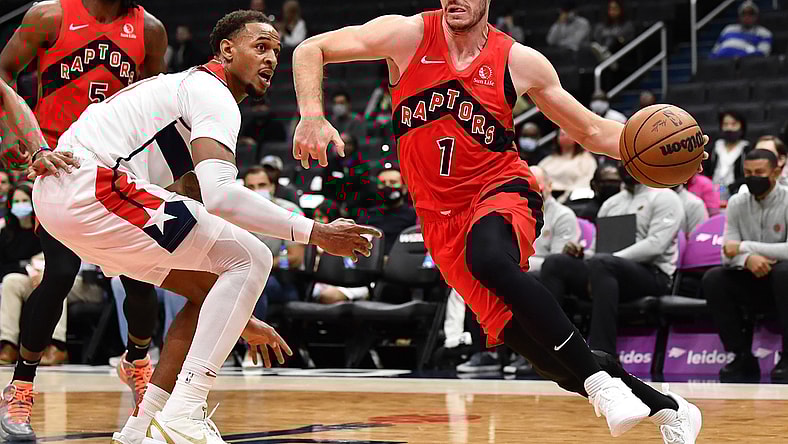 Oct 12, 2021; Washington, District of Columbia, USA; Toronto Raptors guard Goran Dragic (1) dribbles against Washington Wizards center Daniel Gafford (left) during the first half at Capital One Arena. Mandatory Credit: Brad Mills-USA TODAY Sports
