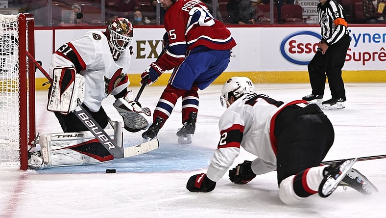 Oct 7, 2021; Montreal, Quebec, CAN; Ottawa Senators goaltender Anton Forsberg (31) makes a save against Montreal Canadiens center Ryan Poehling (25) during the second period at Bell Centre. Mandatory Credit: Jean-Yves Ahern-USA TODAY Sports