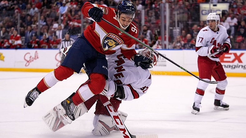 Nov 6, 2021; Sunrise, Florida, USA; Florida Panthers left wing Ryan Lomberg (94) collides with Carolina Hurricanes goaltender Antti Raanta (32) during the second period at FLA Live Arena. Mandatory Credit: Jasen Vinlove-USA TODAY Sports