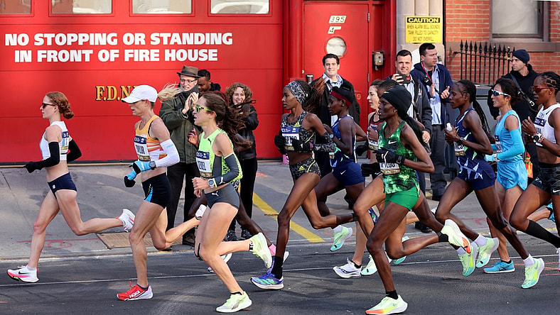 Nov 7, 2021; New York, New York, USA;  Elite runners go by a fire house in Brooklyn during the New York City Marathon.  Mandatory Credit: Kevin R. Wexler-USA TODAY Sports
