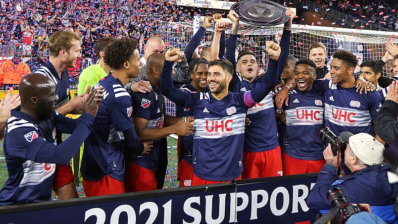 Nov 7, 2021; Foxborough, Massachusetts, USA; New England Revolution forward Gustavo Bou (7) and New England Revolution midfielder Carles Gil (22) celebrate winning the 2021 Supporters  Shield at Gillette Stadium. Mandatory Credit: Paul Rutherford-USA TODAY Sports