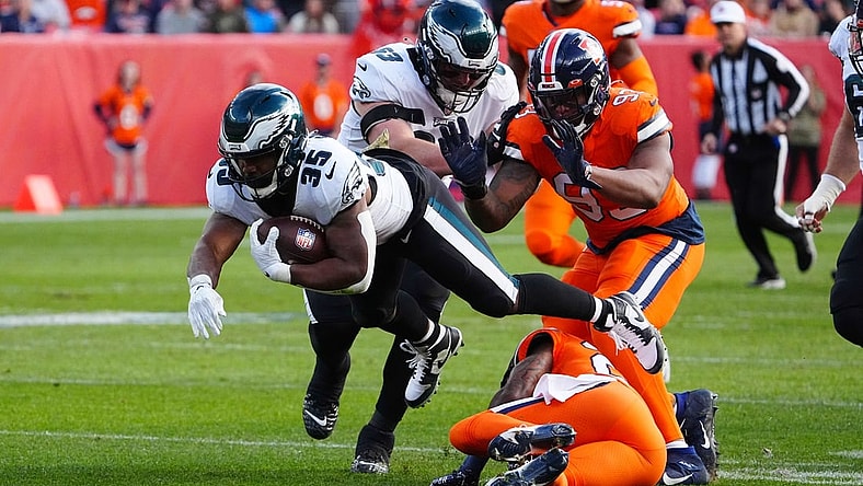 Nov 14, 2021; Denver, Colorado, USA; Philadelphia Eagles running back Boston Scott (35) dives over Denver Broncos safety Kareem Jackson (22) in the first quarter at Empower Field at Mile High. Mandatory Credit: Ron Chenoy-USA TODAY Sports