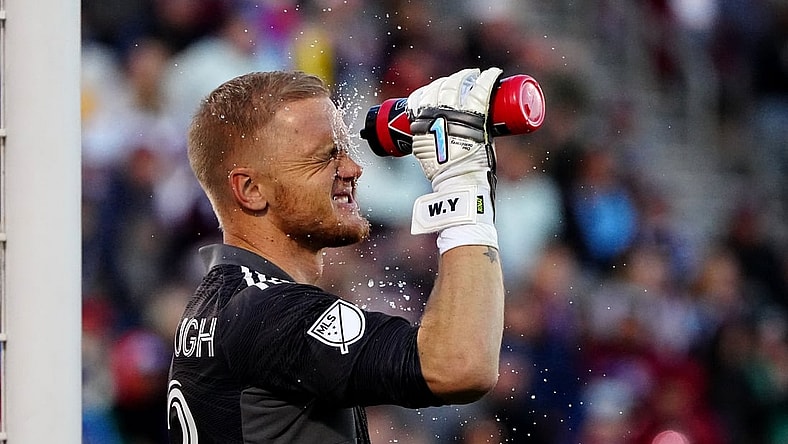 Nov 25, 2021; Commerce City, CO, USA; Colorado Rapids goalkeeper William Yarbrough (22) cools off with a water bottle during the second half against the Portland Timbers at Dick's Sporting Goods Park. Mandatory Credit: Ron Chenoy-USA TODAY Sports