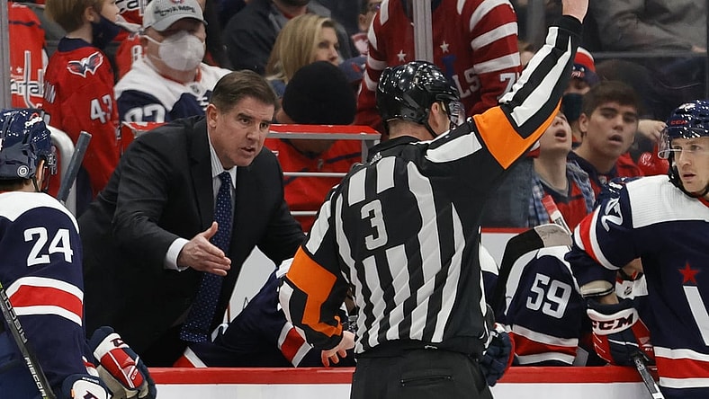 Jan 16, 2022; Washington, District of Columbia, USA; Washington Capitals head coach Peter Laviolette (L) argues a penalty call by referee Mike Leggo (3) during the game against the Vancouver Canucks during the third period at Capital One Arena. Mandatory Credit: Geoff Burke-USA TODAY Sports