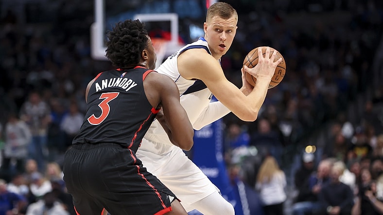 Jan 19, 2022; Dallas, Texas, USA;  Dallas Mavericks center Kristaps Porzingis (6) controls the ball as Toronto Raptors forward OG Anunoby (3) defends during the first quarter at American Airlines Center. Mandatory Credit: Kevin Jairaj-USA TODAY Sports