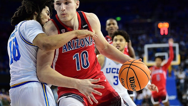 Jan 25, 2022; Los Angeles, California, USA; Arizona Wildcats forward Azuolas Tubelis (10) moves to the basket against UCLA Bruins guard Tyger Campbell (10) during the first half at Pauley Pavilion. Mandatory Credit: Gary A. Vasquez-USA TODAY Sports