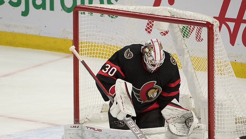 Jan 27, 2022; Ottawa, Ontario, CAN; Ottawa Senators goalie Matt Murray (30) makes a save in overtime against the Carolina Hurricanes  at the Canadian Tire Centre. Mandatory Credit: Marc DesRosiers-USA TODAY Sports