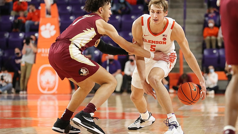 Feb 2, 2022; Clemson, South Carolina, USA; Clemson Tigers forward Hunter Tyson (5) dribbles the ball as Florida State Seminoles guard Jalen Warley (1) defends during the first half at Littlejohn Coliseum. Mandatory Credit: Dawson Powers-USA TODAY Sports