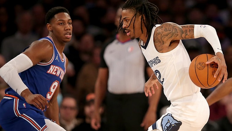 Feb 2, 2022; New York, New York, USA; Memphis Grizzlies guard Ja Morant (12) controls the ball against New York Knicks guard RJ Barrett (9) during the second quarter at Madison Square Garden. Mandatory Credit: Brad Penner-USA TODAY Sports