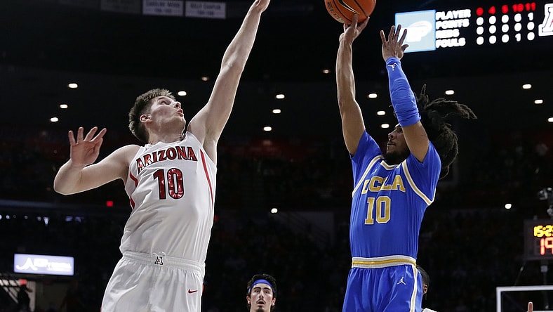Feb 3, 2022; Tucson, Arizona, USA; UCLA Bruins guard Tyger Campbell (10) shoots over Arizona Wildcats forward Azuolas Tubelis (10) during the first half at McKale Center. Mandatory Credit: Chris Coduto-USA TODAY Sports