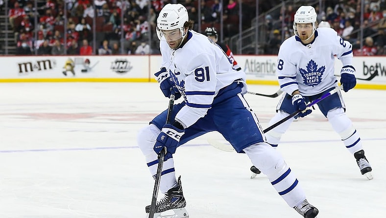 Feb 1, 2022; Newark, New Jersey, USA; Toronto Maple Leafs center John Tavares (91) controls the puck against New Jersey Devils during the first period at Prudential Center. Mandatory Credit: Tom Horak-USA TODAY Sports