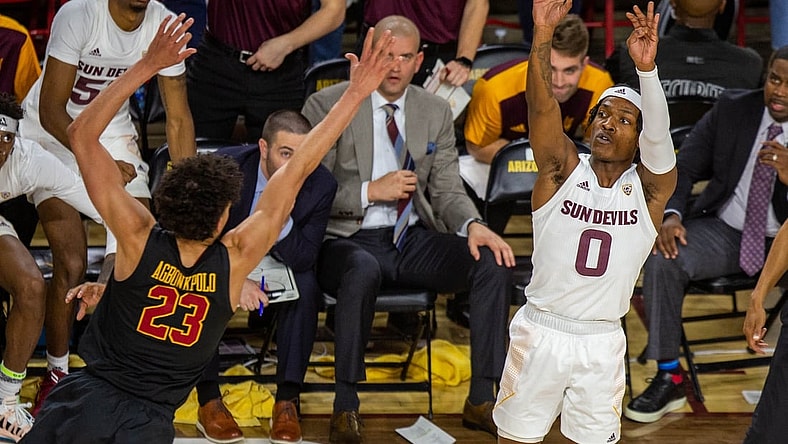 ASU sophomore guard DJ Horne (0) shoots while being guarded by USC junior Max Agbonkpolo (23) at Desert Financial Arena in Tempe, Arizona on Thursday, Feb. 3, 2022.

Asu At Arizona 2022