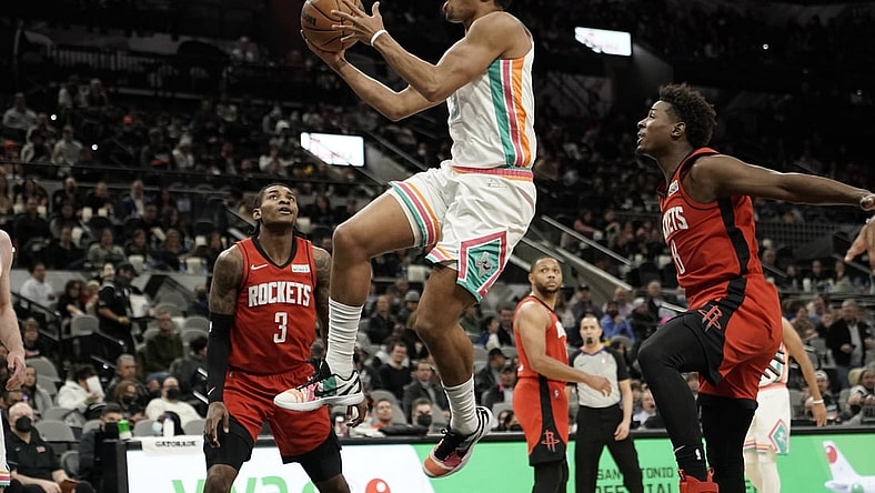 Feb 4, 2022; San Antonio, Texas, USA; San Antonio Spurs forward Keldon Johnson (3) drives to the basket past Houston Rockets forward Jae'Sean Tate (8) during the first half aat AT&T Center. Mandatory Credit: Scott Wachter-USA TODAY Sports
