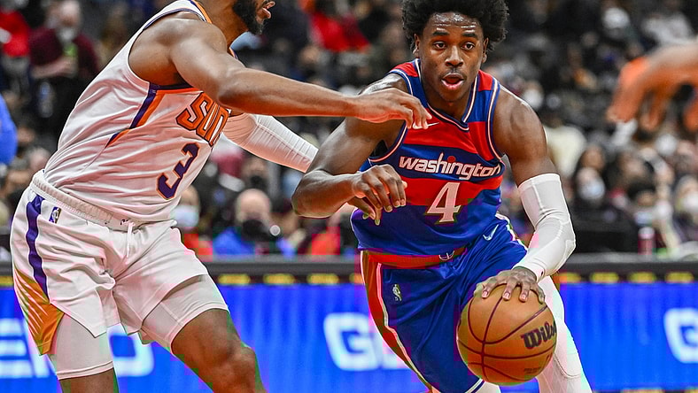 Feb 5, 2022; Washington, District of Columbia, USA; Washington Wizards guard Aaron Holiday (4) dribbles as Phoenix Suns guard Chris Paul (3) defends during the second half at Capital One Arena. Mandatory Credit: Brad Mills-USA TODAY Sports