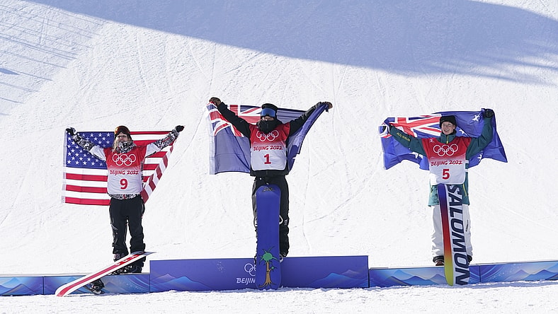 Feb 6, 2022; Zhangjiakou, China; Silver medalist Julia Marino (USA), left, gold medalist Zoi Sadowski Synnott (NZL), center, and bronze medalist Tess Coady (AUS) celebrate in the women's slopestyle snowboarding final during the Beijing 2022 Olympic Winter Games at Genting Snow Park. Mandatory Credit: Jack Gruber-USA TODAY Sports