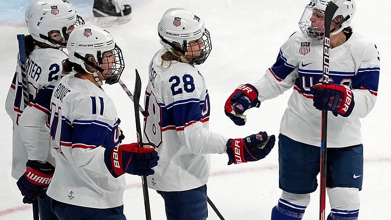 Feb 6, 2022; Beijing, China; Team United States forward Amanda Kessel (28) is congratulated after scoring a goal against Switzerland during the first period during the Beijing 2022 Olympic Winter Games at Wukesong Sports Centre. Mandatory Credit: George Walker IV-USA TODAY Sports