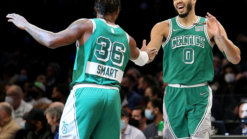Feb 8, 2022; Brooklyn, New York, USA; Boston Celtics forward Jayson Tatum (0) high fives guard Marcus Smart (36) during the first quarter against the Brooklyn Nets at Barclays Center. Mandatory Credit: Brad Penner-USA TODAY Sports