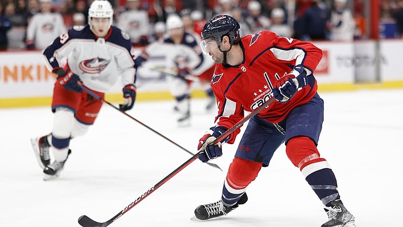 Feb 8, 2022; Washington, District of Columbia, USA; Washington Capitals defenseman Justin Schultz (2) skates with the puck as Columbus Blue Jackets right wing Yegor Chinakhov (59) chase during the third period at Capital One Arena. Mandatory Credit: Geoff Burke-USA TODAY Sports