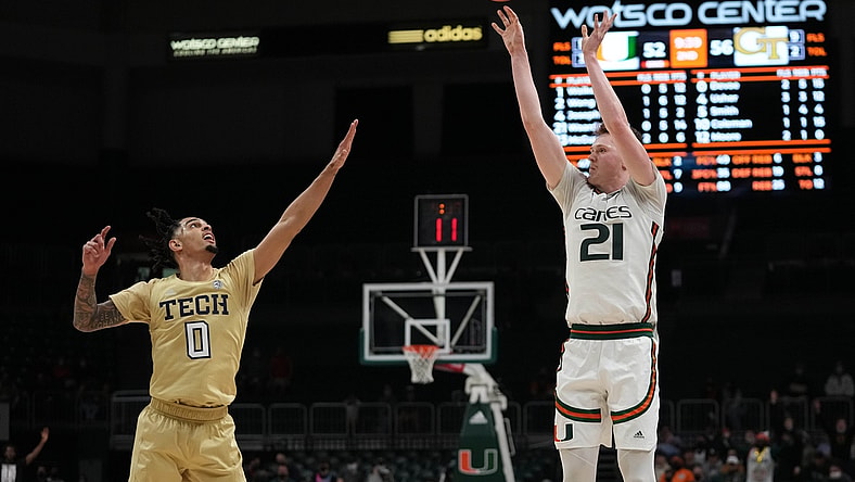Feb 9, 2022; Coral Gables, Florida, USA; Miami Hurricanes forward Sam Waardenburg (21) attempts a three point shot against Georgia Tech Yellow Jackets guard Michael Devoe (0) during the second half at Watsco Center. Mandatory Credit: Jasen Vinlove-USA TODAY Sports