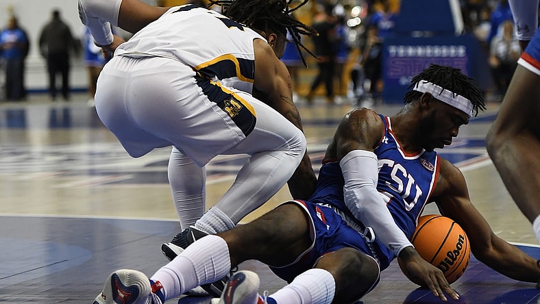 Feb 10, 2022; Nashville, Tennessee, USA; Tennessee State Tigers guard Marcus Fitzgerald Jr. (1) dives on the floor for a loose ball during the first half against the Murray State Racers at Gentry Complex. Mandatory Credit: Christopher Hanewinckel-USA TODAY Sports
