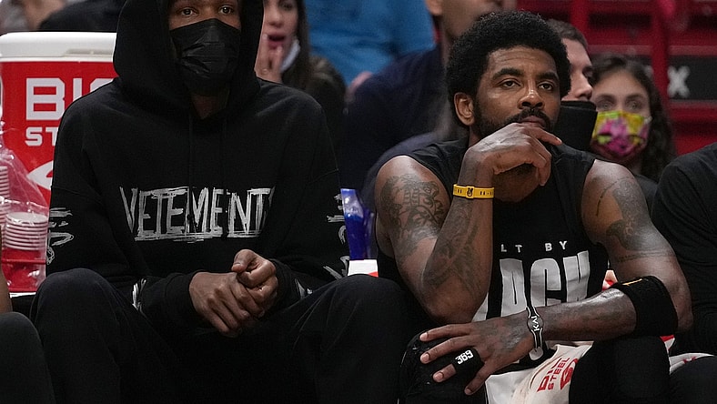 Feb 12, 2022; Miami, Florida, USA; Brooklyn Nets forward Kevin Durant (L) sits next to guard Kyrie Irving (11) during the second half against the Miami Heat at FTX Arena. Mandatory Credit: Jasen Vinlove-USA TODAY Sports