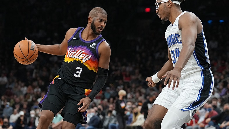 Feb 12, 2022; Phoenix, Arizona, USA; Phoenix Suns guard Chris Paul (3) dribbles against Orlando Magic center Wendell Carter Jr. (34) during the second half at Footprint Center. Mandatory Credit: Joe Camporeale-USA TODAY Sports