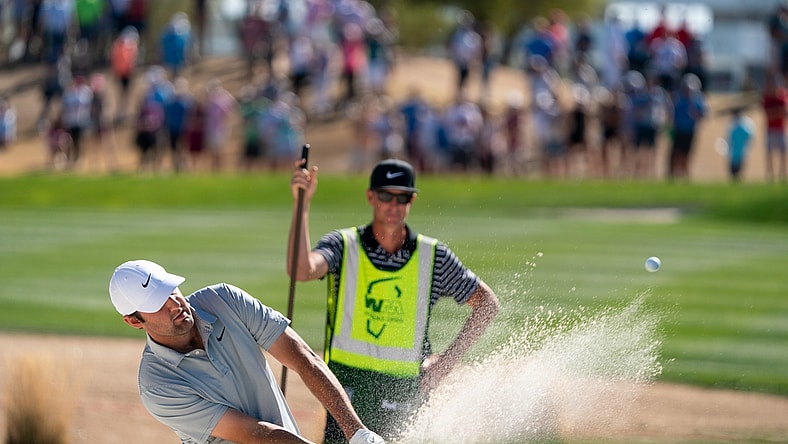 Feb 13, 2022; Scottsdale, Arizona, USA; Scottie Scheffler plays from the green side bunker on the third as caddy J.Tedd Scott looks on during the final round of the WM Phoenix Open golf tournament. Mandatory Credit: Allan Henry-USA TODAY Sports