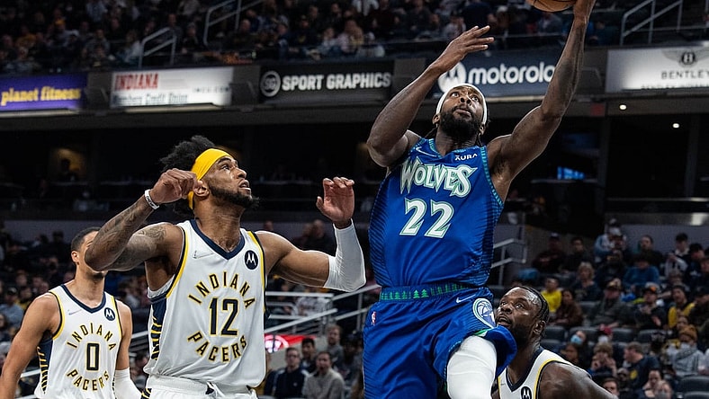 Feb 13, 2022; Indianapolis, Indiana, USA; Minnesota Timberwolves guard Patrick Beverley (22) shoots the ball while Indiana Pacers forward Oshae Brissett (12) defends in the first half at Gainbridge Fieldhouse. Mandatory Credit: Trevor Ruszkowski-USA TODAY Sports