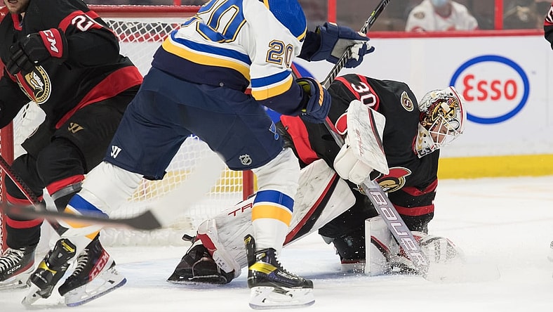 Feb 15, 2022; Ottawa, Ontario, CAN; Ottawa Senators goalie Matt Murray (30) makes a save in front of St. Louis Blues left wing Brandon Saad (20) in the first period at the Canadian Tire Centre. Mandatory Credit: Marc DesRosiers-USA TODAY Sports