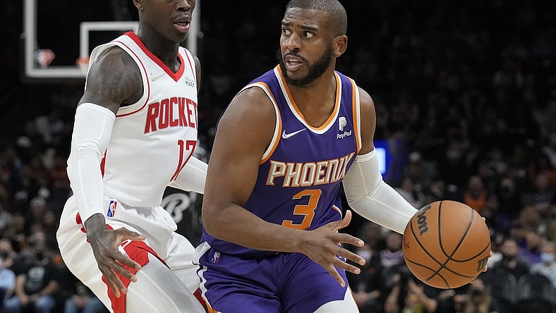 Feb 16, 2022; Phoenix, Arizona, USA; Phoenix Suns guard Chris Paul (3) drives past Houston Rockets guard Dennis Schroeder at Footprint Center. Mandatory Credit: Rick Scuteri-USA TODAY Sports