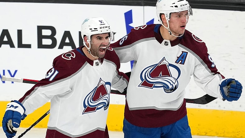 Feb 16, 2022; Las Vegas, Nevada, USA; Colorado Avalanche right wing Mikko Rantanen (96) celebrates with center Nazem Kadri (91) after scoring a power-play goal against the Vegas Golden Knights during the third period at T-Mobile Arena. Mandatory Credit: Stephen R. Sylvanie-USA TODAY Sports