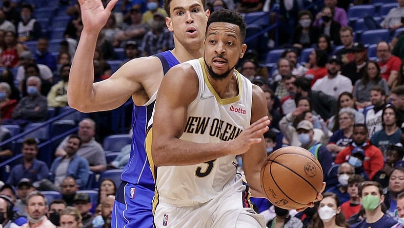 Feb 17, 2022; New Orleans, Louisiana, USA;  New Orleans Pelicans guard CJ McCollum (3) dribbles against Dallas Mavericks center Dwight Powell (7) during the second half at the Smoothie King Center. Mandatory Credit: Stephen Lew-USA TODAY Sports