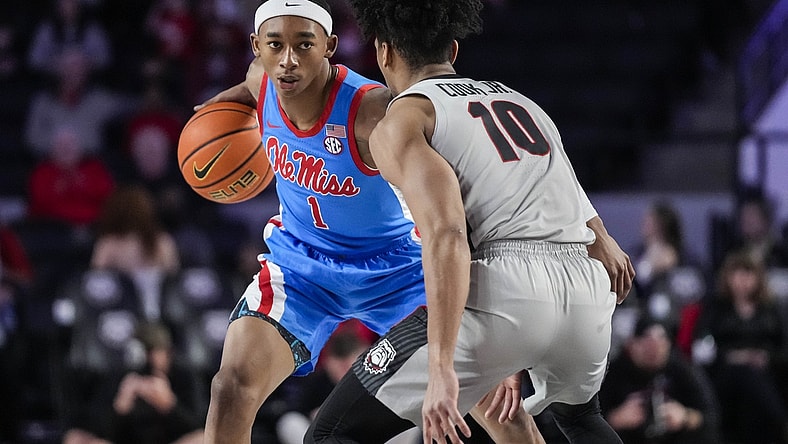 Feb 19, 2022; Athens, Georgia, USA; Mississippi Rebels guard Austin Crowley (1) dribbles against Georgia Bulldogs guard Aaron Cook (10) during the first half at Stegeman Coliseum. Mandatory Credit: Dale Zanine-USA TODAY Sports