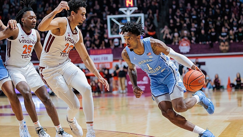 Feb 19, 2022; Blacksburg, Virginia, USA; North Carolina Tar Heels forward Leaky Black (1) drives past Virginia Tech Hokies forward Keve Aluma (22) during the first half at Cassell Coliseum. Mandatory Credit: Ryan Hunt-USA TODAY Sports