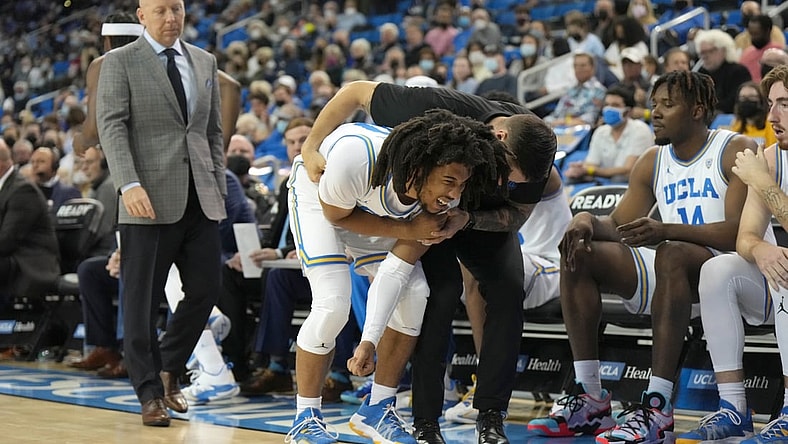 Feb 19, 2022; Los Angeles, California, USA; UCLA Bruins guard Tyger Campbell (10) reacts after suffering an injury against the Washington Huskies in the first half at Pauley Pavilion presented by Wescom. Mandatory Credit: Kirby Lee-USA TODAY Sports