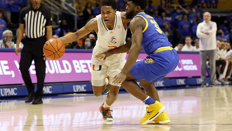 Feb 22, 2022; Pittsburgh, Pennsylvania, USA; Miami (Fl) Hurricanes guard Charlie Moore (3) dribbles the ball against Pittsburgh Panthers guard Onyebuchi Ezeakudo (31) during the first half at the Petersen Events Center. Mandatory Credit: Charles LeClaire-USA TODAY Sports