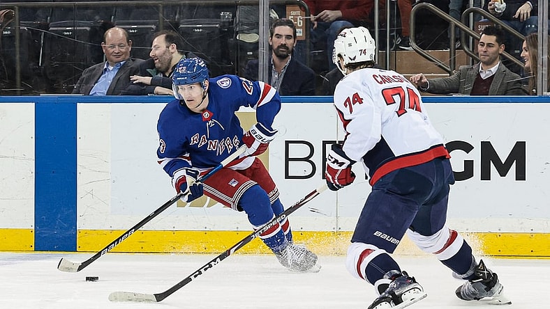 Feb 24, 2022; New York, New York, USA; New York Rangers defenseman Adam Fox (23) controls the puck as Washington Capitals defenseman John Carlson (74) defends during the first period at Madison Square Garden. Mandatory Credit: Vincent Carchietta-USA TODAY Sports