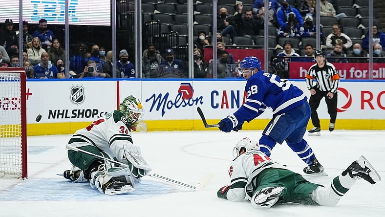 Feb 24, 2022; Toronto, Ontario, CAN; Minnesota Wild goaltender Kaapo Kahkonen (34) makes a save on Toronto Maple Leafs forward Michael Bunting (58) as Minnesota Wild defenseman Jared Spurgeon (46) dives to help out during the first period at Scotiabank Arena. Mandatory Credit: John E. Sokolowski-USA TODAY Sports