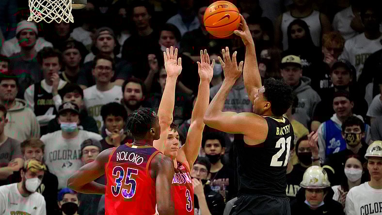 Feb 26, 2022; Boulder, Colorado, USA; Colorado Buffaloes forward Evan Battey (21) shoots over Arizona Wildcats guard Pelle Larsson (3) and center Christian Koloko (35) in the first half at the CU Events Center. Mandatory Credit: Ron Chenoy-USA TODAY Sports