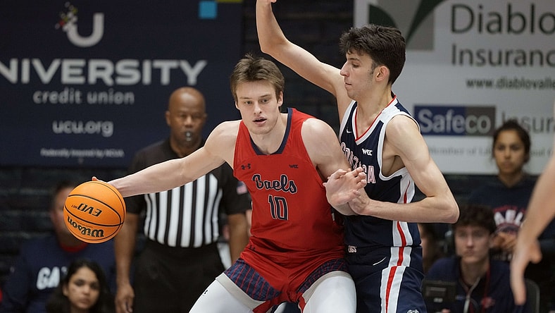 Feb 26, 2022; Moraga, California, USA; Saint Mary's Gaels center Mitchell Saxen (10) handles the ball while being defended by Gonzaga Bulldogs center Chet Holmgren (34) during the first half at University Credit Union Pavilion. Mandatory Credit: Darren Yamashita-USA TODAY Sports