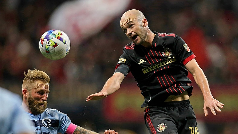 Feb 27, 2022; Atlanta, Georgia, USA; Sporting Kansas City midfielder Oriol Rosell (6) battles for the ball against Atlanta United defender Andrew Gutman (15) during the first half at Mercedes-Benz Stadium. Mandatory Credit: Brett Davis-USA TODAY Sports