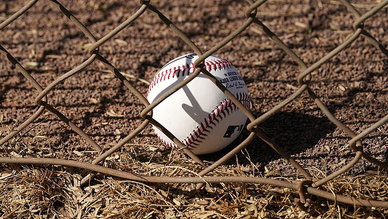 Feb 23, 2021; Scottsdale, Arizona, USA; A baseball resorts against the fence during spring training workouts at Salt River Fields at Talking Stick. Mandatory Credit: Rob Schumacher/Arizona Republic-USA TODAY Sports