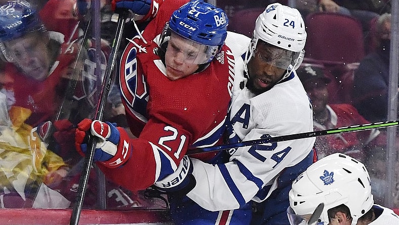 Sep 27, 2021; Montreal, Quebec, CAN; Toronto Maple Leafs forward Wayne Simmonds (24) checks Montreal Canadiens defenseman Kaiden Guhle (21) during the third period at the Bell Centre. Mandatory Credit: Eric Bolte-USA TODAY Sports
