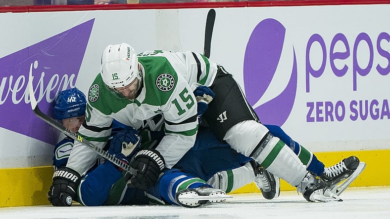 Nov 7, 2021; Vancouver, British Columbia, CAN; Dallas Stars forward Blake Comeau (15) checks Vancouver Canucks forward Elias Pettersson (40) in the second period at Rogers Arena. Mandatory Credit: Bob Frid-USA TODAY Sports